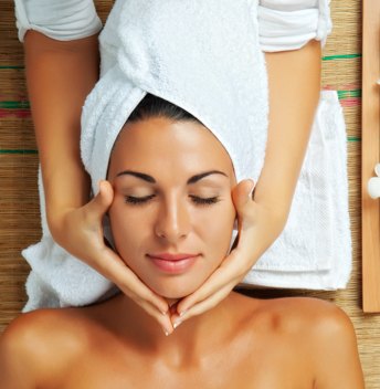 A woman treating herself to facial spa skin services for beauty and regeneration